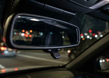 Para que serve o pequeno botão na base do retrovisor interno do carro e quando ele deve ser usado