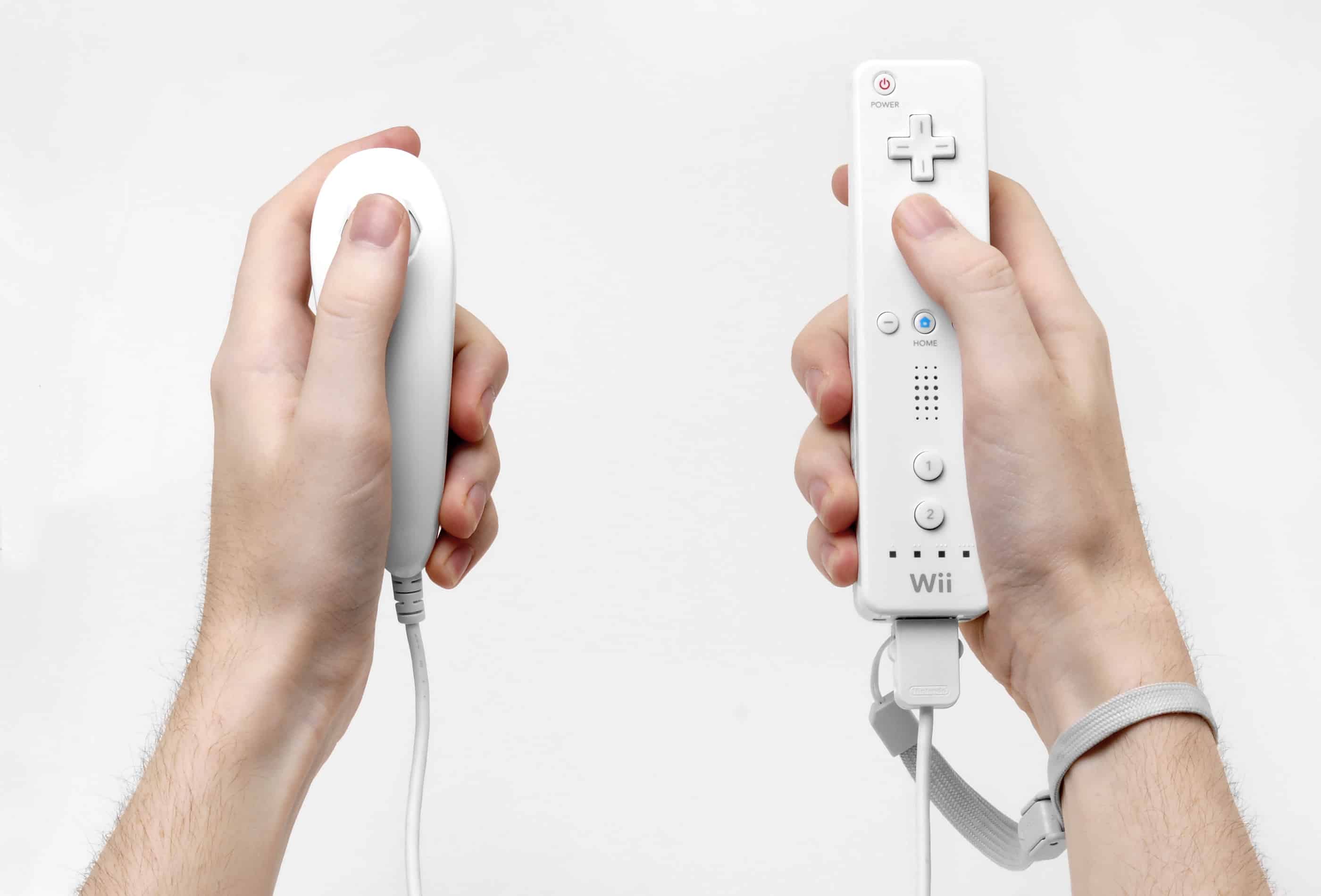 Um Wiimote, o controle sensível a movimento do Wii (na mão direita)