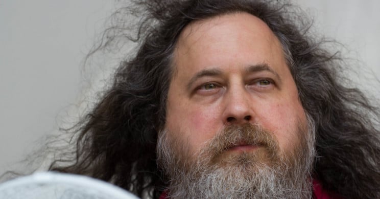 Imagem mostra Richard Stallman, com cabelos e barba longos, respondendo a perguntas