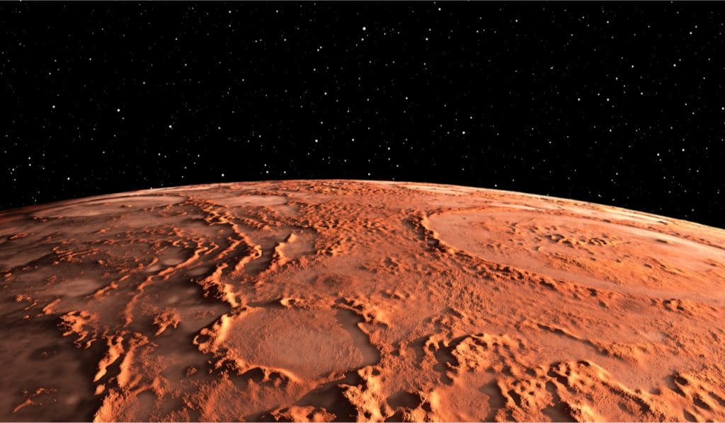 Ilustração digital mostra o contorno de Marte, com o solo bem vermelho e um fundo estrelado negro simbolizando o espaço