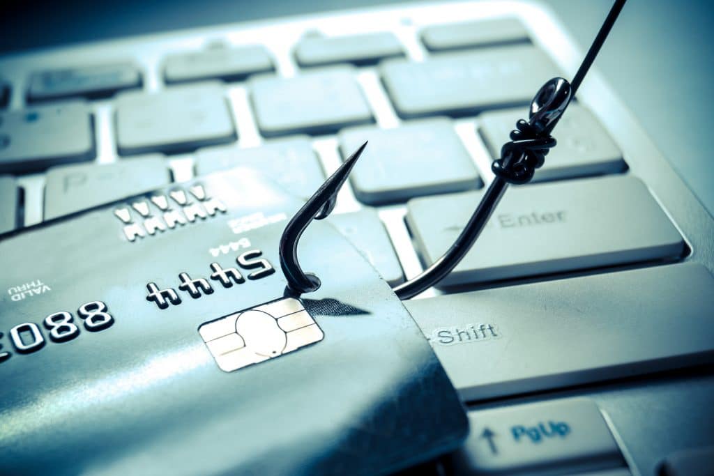 Anzol fisgando um cartão, ilustrando prejuízos do phishing