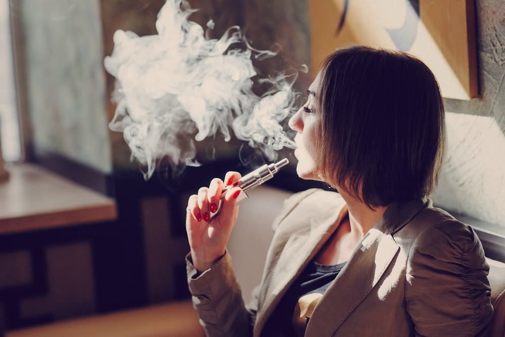 Mulher fumando cigarro eletrônico