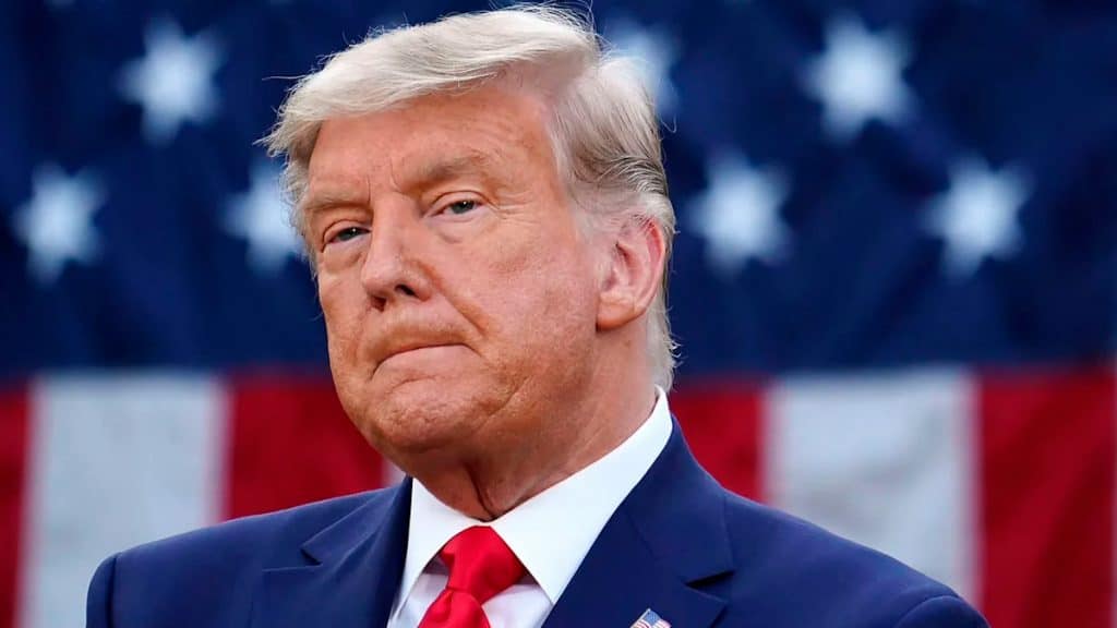 Donald Trump com bandeira dos EUA ao fundo