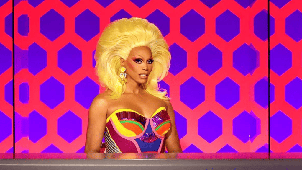 RuPaul na mesa de jurados durante a final da temporada 15 (2023) via WoW