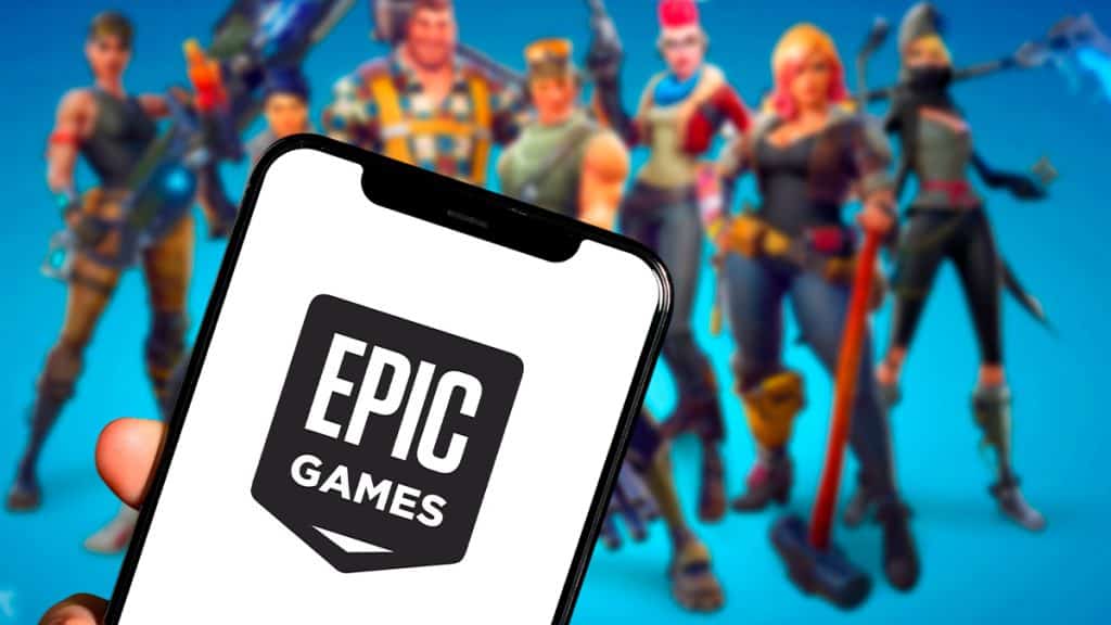 Fortnite poderá ser jogado direto no Discord em alguns países A Epic Games lançou um novo modo de demonstração do Fortnite dentro do Discord, permitindo que jogadores testem o battle royale sem precisar baixá-lo. O recurso é oferecido por meio do serviço de streaming GeForce Now, da Nvidia, e marca o primeiro experimento conjunto entre as empresas. Pessoa segurando celular com logotipo da Epic Games e personagens de Fortnite ao fundo