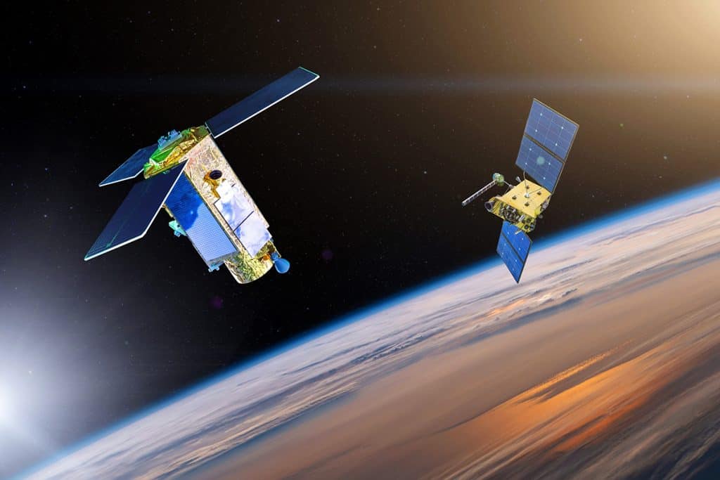 Representação artística de dois satélites se encontrando na órbita da Terra (Crédito: aappp/ Shutterstock)