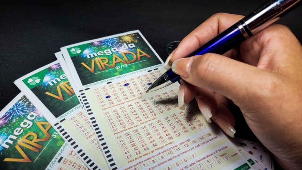 Pessoa fazendo jogo com caneta na Mega da Virada