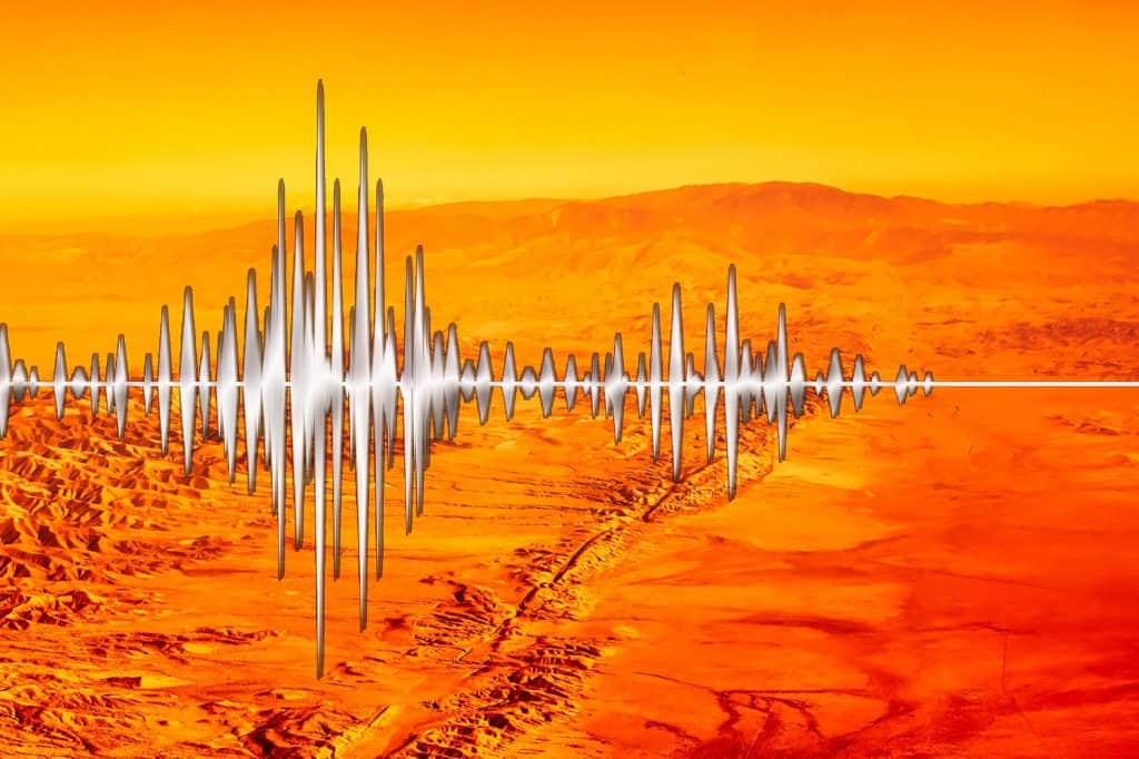 Linha indicando terremoto, com a falha de San Andreas ao fundo