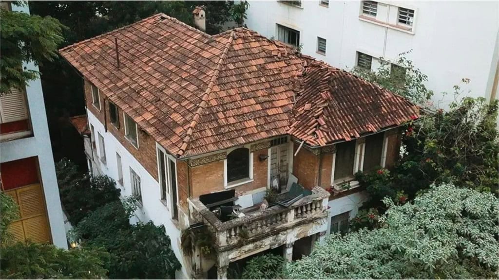 5 fatos chocantes sobre “A Mulher da Casa Abandonada” De um postcast viral do jornalista Chico Felitti em 2022, ao documentário laçando pelo Prime Video agora em agosto de 2025, “A mulher da casa abandonada” revela uma história real, triste e perturbadora. Quem diria que de um fato curioso, uma casa abandonada em meio aos prédios do bairro Higienópolis, surgiria a descoberta mais macabra de uma realidade não muito distante. Mansão antiga abandona no bairro Higienópolis vista do alto