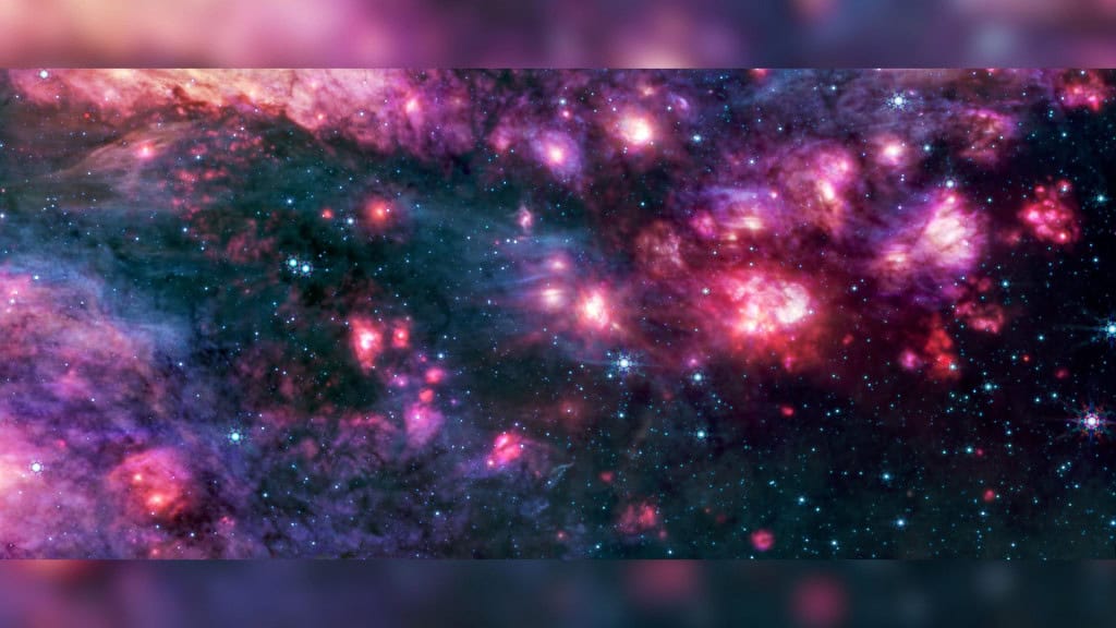 James Webb revela segredos do maior berçário estelar da Via Láctea O telescópio espacial James Webb capturou imagens inéditas da Sagittarius B2, a maior nuvem formadora de estrelas da Via Láctea. Localizada a poucas centenas de anos-luz do buraco negro central da galáxia, essa região imensa concentra poeira cósmica, gás e estrelas em formação numa escala que astrônomos nunca tinham visto com tanto detalhe. O MIRI do telescópio James Webb mostra a região B2 de Sagitário em luz infravermelha média, com poeira quente brilhando intensamente