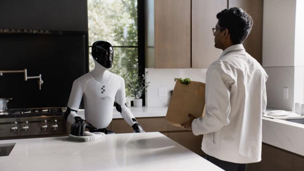 Figure 03: o robô humanoide que quer levar a IA da nuvem para o chão da sua casa O Figure 03, robô humanoide lançado pela startup americana Figure AI nesta semana, foi eleito uma das melhores invenções de 2025 pela revista Time. O modelo promete levar a inteligência artificial (IA) para o mundo físico, com mãos sensíveis, câmeras nas palmas e um sistema capaz de aprender tarefas humanas com poucos dados. Homem segurando sacola de compras e olhando para robô Figure 03 em sua cozinha