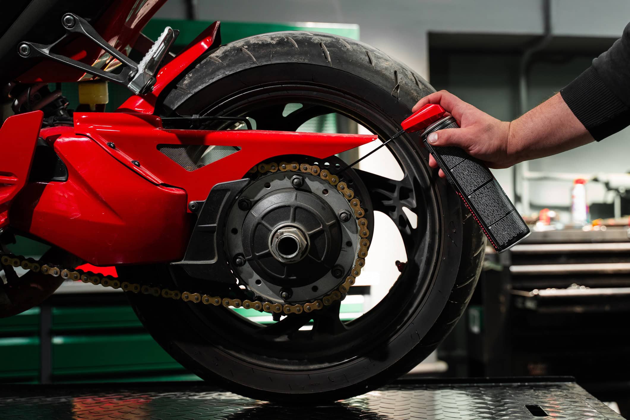 Quando limpar, ajustar e lubrificar a corrente da moto? A corrente é um dos componentes mais importantes da moto, já que ela quem transfere toda a força gerada pelo motor para a roda traseira e, sem esse ela a moto não sairia do lugar. Pessoa faz lubrificação da corrente da moto